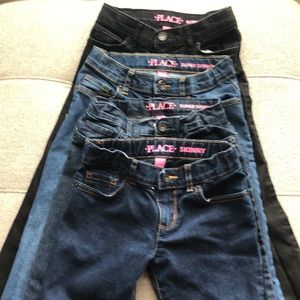 Children’s Place Girls skinny jeans; dark blue, medium blue, blue and black.